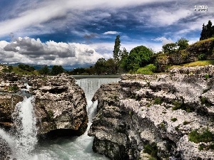 Stones, clouds, waterfall