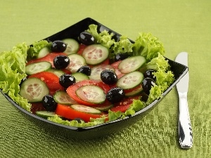 lettuce, olives, cucumbers, cutlery, tomatoes